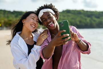 Influencer couple taking selfie on tropical beach, enjoying vacation, social media content creation