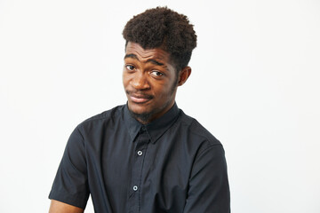 Black man with a playful expression, wearing a stylish black shirt, showcasing confidence and charm...