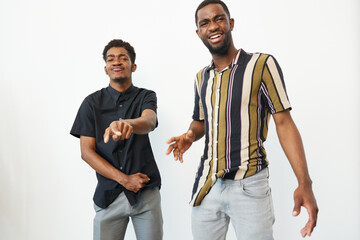 Two joyful African American men laughing together, showcasing happiness and friendship in a bright,...