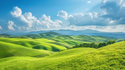 Obraz premium Wide view of rolling green hills under blue sky stock photo --ar 16:9 --raw --v 6 Job ID: c22638f7-f77a-47de-b9ad-2d5d54cd3641