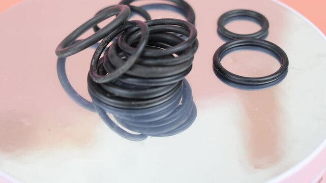 Black hydraulic and pneumetic O-ring. Rubber seal for sanitary ware on rotating display.