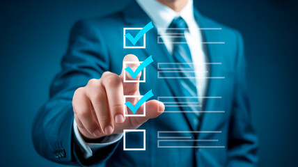 Businessman checking off tasks on a digital list suit