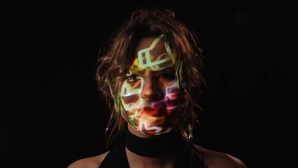 Portrait of a woman with projection of social network reaction symbols on her face