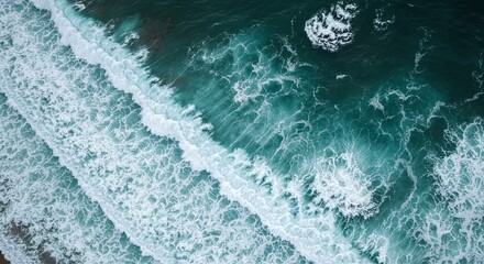 Aerial View of Ocean Waves Rolling Onto Shore with Turquoise Water and White Foam