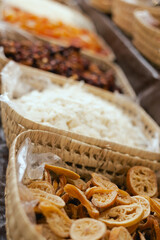 Dried fruit on sale at outdoor farmer market. The fruit shrinks during this process, leaving a...