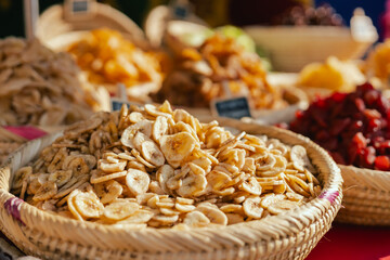 Dried fruit on sale at outdoor farmer market. The fruit shrinks during this process, leaving a...