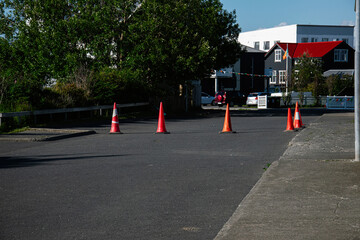 Street in Akranes, Iceland with traffic cones and Irish flag in the background