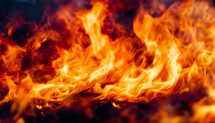 Fototapeta premium Vibrant Blaze of Flames Dancing Against a Dark Background, Creating a Mesmerizing Fiery Spectacle
