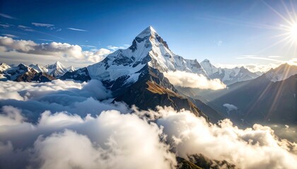 Majestic mountain peak above clouds, sunlight rays breaking through