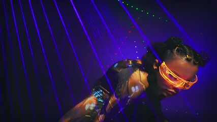 Fashion model posing, fantasy cyborg woman robot costume glowing yellow glasses cyberpunk style braid. Sexy warrior girl dancing in night club virtual reality game laser lighting blue fantastic light - Powered by Adobe