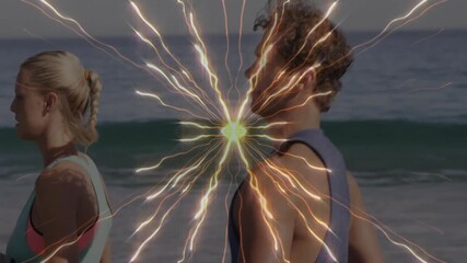 Bursting radial light effect starting fitness group jogging along sandy beach for sunrise session