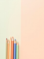 Color pencils aligned on a dual-toned background, creating a visual break between pastel shades