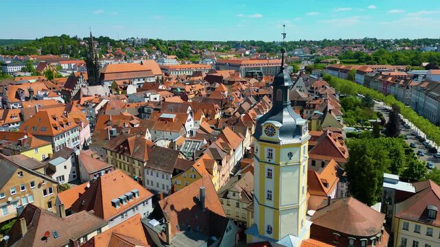4K Aerial Drone Video of the Historic Herrieder Clock Tower and the St. Johannis Church in the Old Town area of Downtown Ansbach, Germany