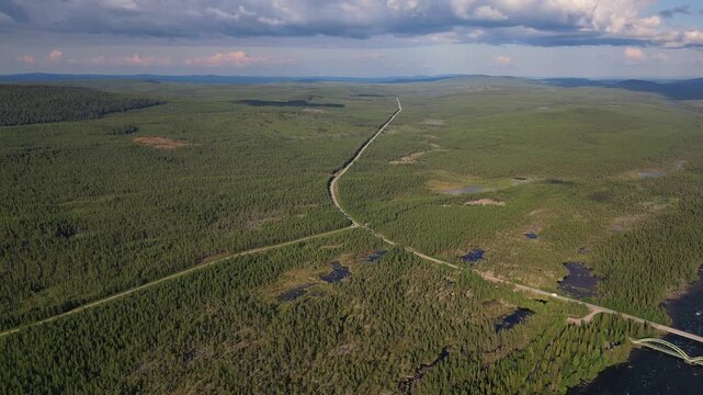 Drone footage captures the E45 highway bridge and parallel rail bridge crossing the Kalixalven River