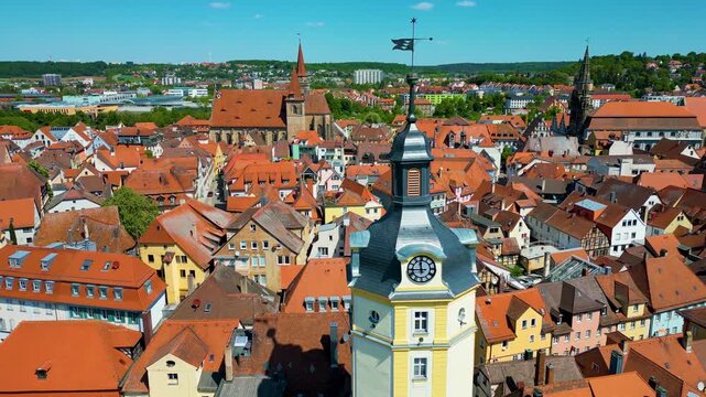 4K Aerial Drone Video of the Historic Herrieder Clock Tower and the St. Johannis Church in the Old Town area of Downtown Ansbach, Germany
