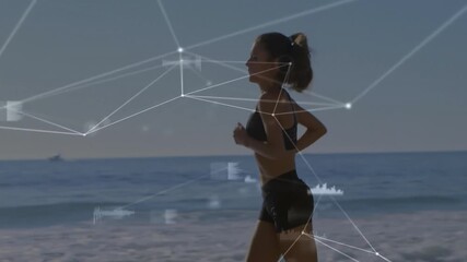 Camera panning revealing runner jogging on beach with tech overlay linking data points to motion - Powered by Adobe