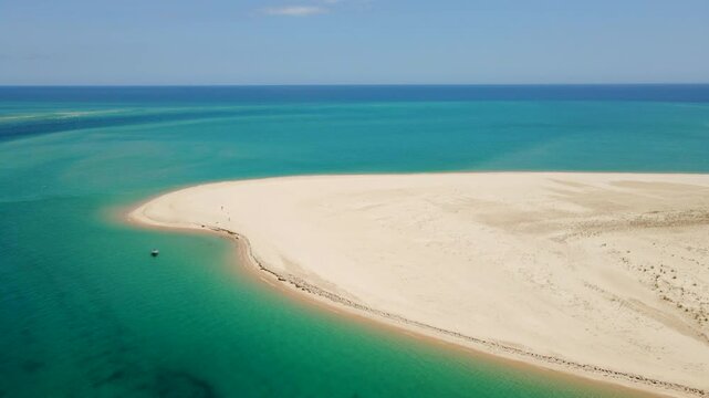 Aerial view of a deserted sandy island with turquoise waters on the Algarve coast, near Armona Island, Portugal, on a bright summer day.