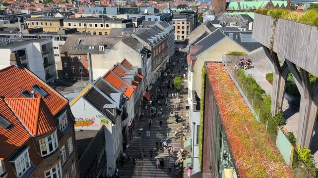 Aarhus, Denmark - July 10, 2025: View of Aarhus with cafes and comercial buildings around the river Aarhus Aa. Downtown Aarhus with restaurants along the canal. View to city center, view from above