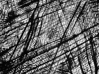 Abstract patterns created by crossing lines and textures in black and white on a textured surface