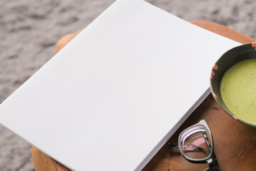 blank magazine mockup on coffee table with green matcha tea