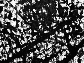 Abstract black and white artwork featuring intricate patterns resembling tree branches and leaves in a dynamic composition