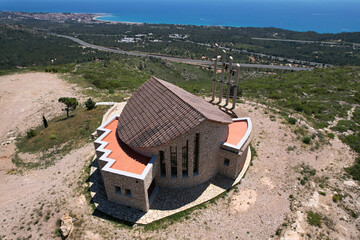 Aerial view of Ermita de Sant Roc on sunny summer day. L'Hospitalet de l'Infant, Tarragona, Spain.