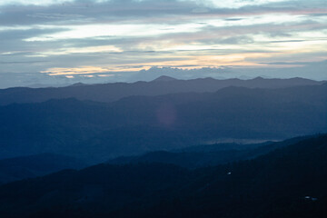 Fototapeta premium Sunrise over Doi Inthanon amidst mist, nature meets tranquility A perfect view for sightseeing and timeless beauty
