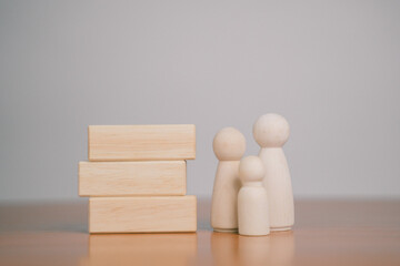 Several wooden blocks are placed on a table with a white background.	
