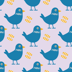 A blue bird with yellow stripes is standing in front of a pile of bread