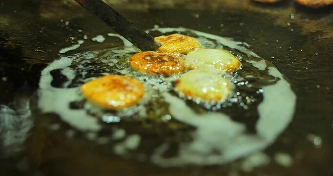 Indian caterers preparing delicious chat, panipuri, and patis at a festive event, showcasing vibrant flavors and traditional street food culture