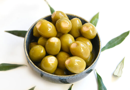 These Greek green olives are stuffed with aromatic garlic, offering a bold, savory flavor. Perfect as a snack, side, or appetizer, they bring a zesty Mediterranean taste to every bite. - Powered by Adobe