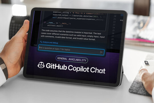 Programmer using github copilot chat on tablet for code analysis and debugging