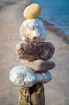 A tower of stones on a pole on the beach of the Baltic Sea.
