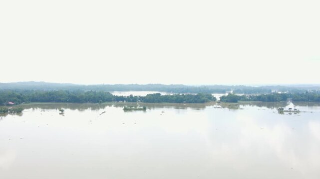Flooded Haor Landscape With Scattered Patches of Land Barely Visible in Bangladesh, South Asia - Aerial Pullback Shot