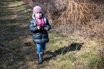 Young photographer walking in nature taking pictures