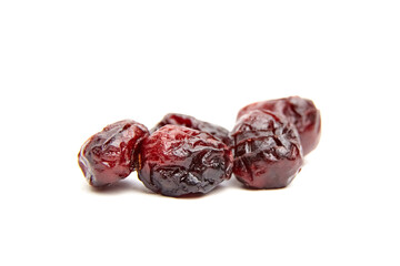 Dried cranberries arranged on a white background, showcasing their rich color and texture,...