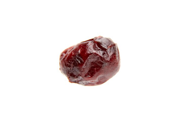Close-up of a single dried cranberry with wrinkled texture and glossy surface, isolated on a clean white background for food and nutrition concepts
