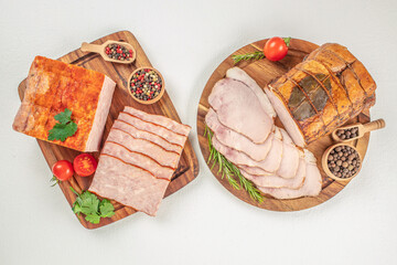 A delicious assortment of smoked and cooked meats is beautifully arranged on wooden boards with...