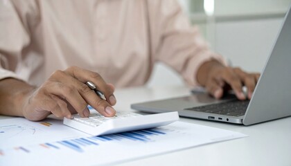 Man using calculator, writing notes, financial report analysis, accounting desk setup, business budget planning, working on laptop, professional finance review, income tracking chart, expense calculat