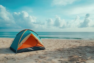 Colorful camping tent on a serene beach during a calm summer morning with gentle waves