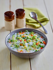 rice congee prepared with carrot, peas, and corn