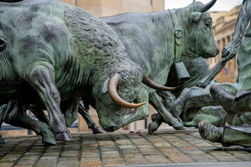 San Fermin sculpture in Pamplona depicts traditional bull-running festival with intricate bronze...
