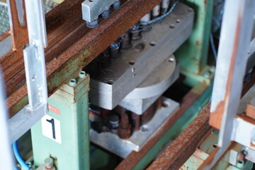 Close-Up of Industrial Machine Assembly with Bolted Components and Label – Workshop Maintenance Scene