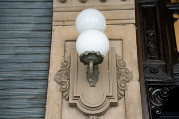 Historic street lamp illuminating the architecture in Pamplona, Navarra, Spain during late afternoon