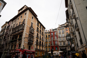 Beautiful architecture in Pamplona, Navarra Spain showcasing vibrant buildings and a cloudy sky
