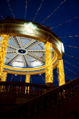 Illuminated gazebo in Plaza del Castillo at night in Pamplona, Navarra, Spain during festive celebrations