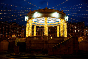 Plaza del Castillo illuminated at night with festive lights in Pamplona, Navarra, Spain