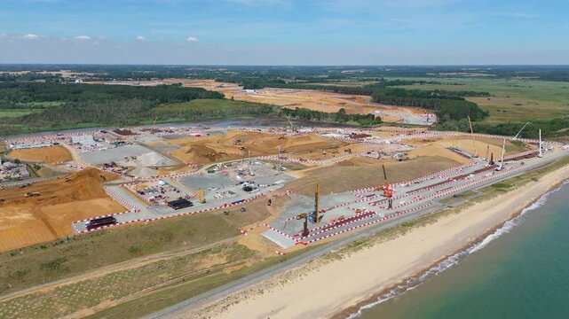 Sizewell C nuclear power plant under construction, aerial drone view, future power energy generation, heavy crane plant machinery England UK