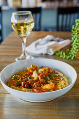 shrimp and grits topped with andouille sausage, bell peppers and Tasso ham gravy