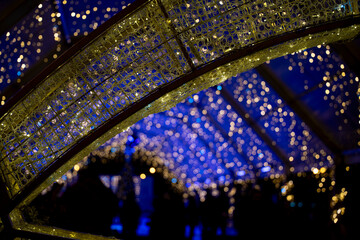 Festive lighting illuminates evening gathering in Pamplona, Navarra during winter celebration